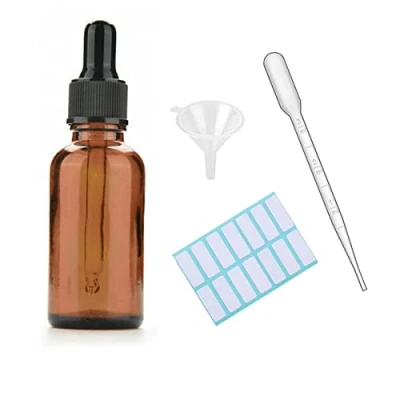 Immagine di 1 flacone contagocce in vetro ambrato con tappo nero, pipetta misurata, imbuto ed etichette; da 30 ml per di olio essenziale ricaricabile