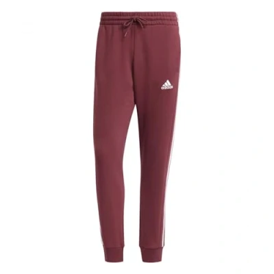Immagine di adidas Uomo Essentials Fleece 3 Stripes Tapered Cuff Pants, Shadow Red, 4XL Short