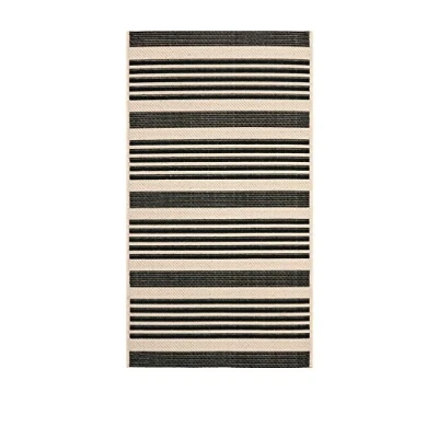 Immagine di SAFAVIEH Tappeto Geometrico per Soggiorno, Sala da pranzo, Camera letto Courtyard Collection, A Pelo Corto, Nero e osso, 79 X 152 cm