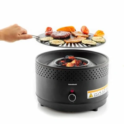 Immagine di InnovaGoods® Barbecue da tavolo, a carbone senza fumo e odori, griglia portatile per cucinare in interni ed esterni con tutti i comfort, adattabile batterie o connessione USB C.