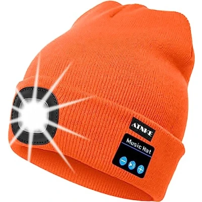 Immagine di ATNKE Berretto Bluetooth con LED Illuminato, USB Ricaricabile Wireless Musicale Cappello da Corsa Ultra Bright 4 Impermeabile Lampada Uso per Sci Escursionismo Campeggio Ciclismo (Arancia)